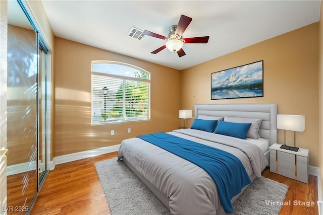 11082 Sospel Pl, Las Vegas, NV 89141 - bedroom with baseboards, light wood-style flooring, a closet, and a ceiling fan