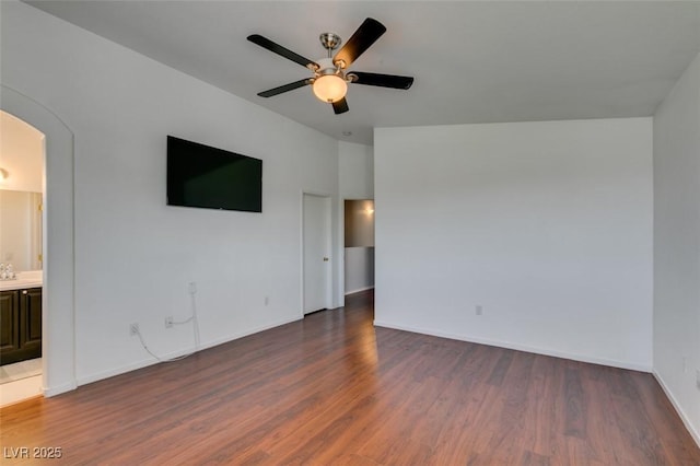 9362 Straw Hays St Unit 103, Las Vegas, NV 89178 - unfurnished room with arched walkways, wood finished floors, a ceiling fan, and baseboards