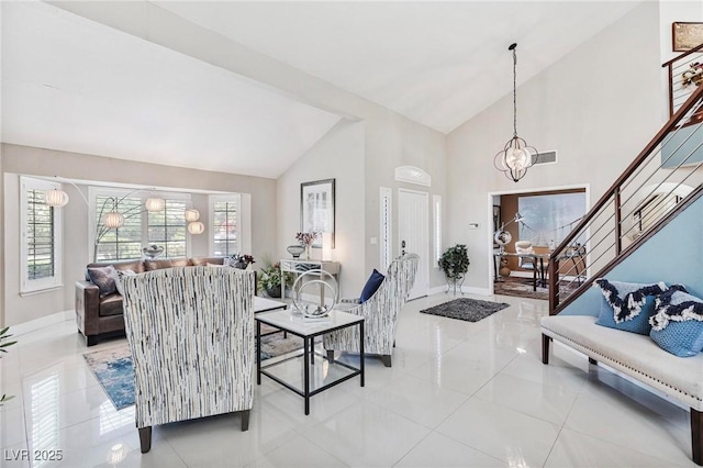 2222 Lucerne Ct, Henderson, NV 89014 - tiled living area featuring baseboards, high vaulted ceiling, stairs, and a chandelier
