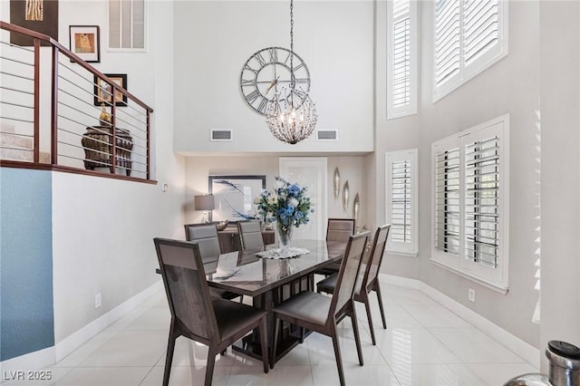 2222 Lucerne Ct, Henderson, NV 89014 - tiled dining space featuring a high ceiling, a chandelier, plenty of natural light, and baseboards