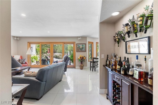 2222 Lucerne Ct, Henderson, NV 89014 - living room with a bar, recessed lighting, light tile patterned floors, baseboards, and a textured ceiling
