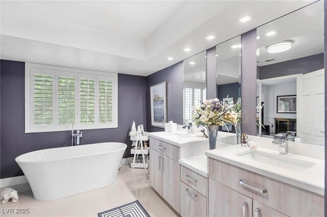 2222 Lucerne Ct, Henderson, NV 89014 - bathroom with double vanity, a freestanding bath, recessed lighting, and baseboards