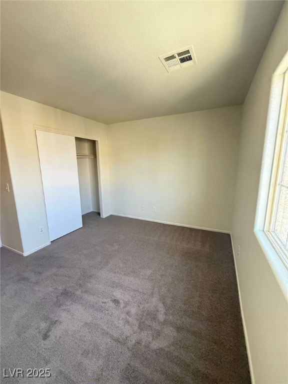 7469 Margollini St, Las Vegas, NV 89148 - unfurnished bedroom with carpet, baseboards, and a closet