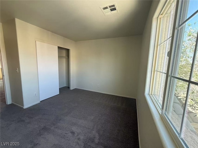 7469 Margollini St, Las Vegas, NV 89148 - unfurnished bedroom featuring dark carpet, baseboards, and a closet