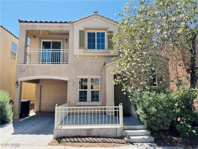 7469 Margollini St, Las Vegas, NV 89148 - view of front of property featuring concrete driveway, an attached garage, stucco siding, a balcony, and a tile roof