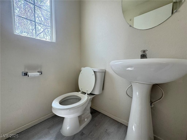 7469 Margollini St, Las Vegas, NV 89148 - bathroom with toilet, baseboards, and wood finished floors