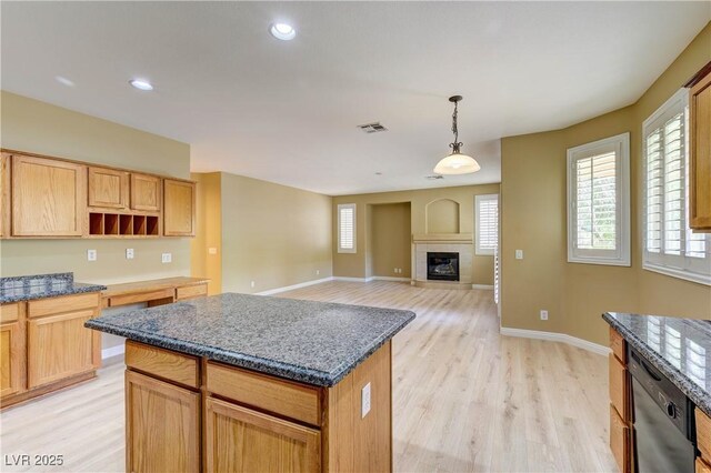 11478 Bargetto Ct, Las Vegas, NV 89141 - kitchen with dishwasher, light wood finished floors, a kitchen island, dark stone countertops, and recessed lighting