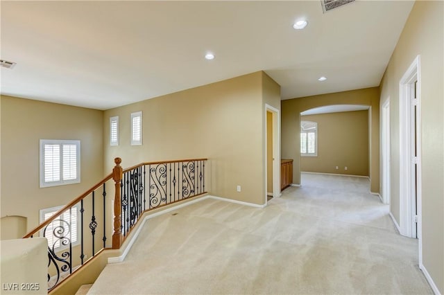 11478 Bargetto Ct, Las Vegas, NV 89141 - hall featuring arched walkways, light colored carpet, an upstairs landing, baseboards, and recessed lighting