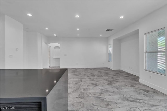 4016 Owlshead Mountain St, Las Vegas, NV 89129 - empty room featuring arched walkways, recessed lighting, light marble finish flooring, and baseboards
