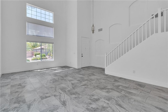 4016 Owlshead Mountain St, Las Vegas, NV 89129 - entryway with a high ceiling, stairway, baseboards, and marble look tiles