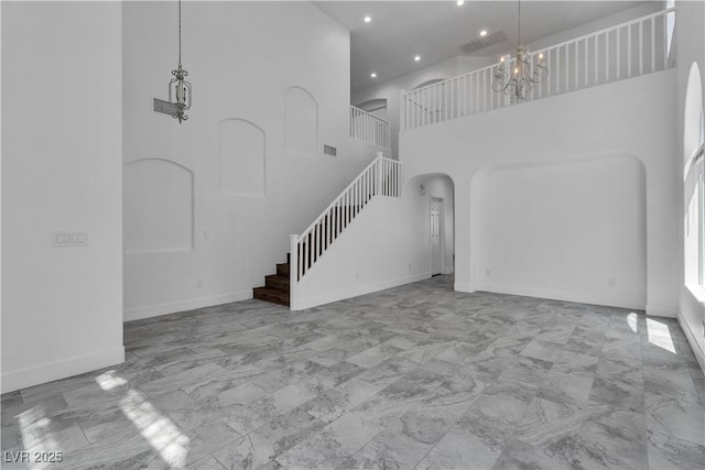 4016 Owlshead Mountain St, Las Vegas, NV 89129 - unfurnished living room with stairs, arched walkways, a chandelier, marble look tile flooring, and recessed lighting