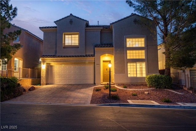4016 Owlshead Mountain St, Las Vegas, NV 89129 - mediterranean / spanish house featuring a tile roof, stucco siding, driveway, and a garage