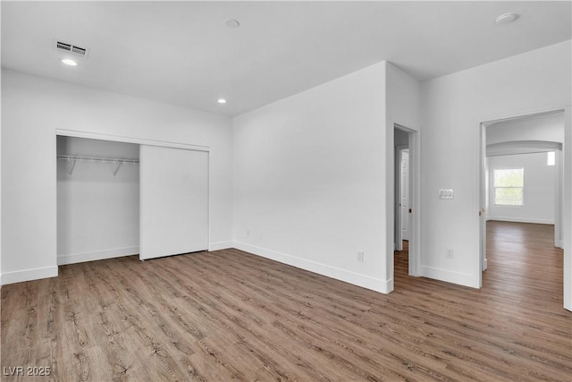 4016 Owlshead Mountain St, Las Vegas, NV 89129 - unfurnished bedroom with wood finished floors, baseboards, a closet, arched walkways, and recessed lighting