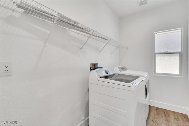 4016 Owlshead Mountain St, Las Vegas, NV 89129 - laundry room with light wood finished floors, washer and dryer, and baseboards