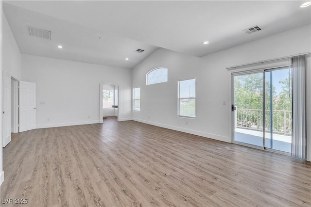 4016 Owlshead Mountain St, Las Vegas, NV 89129 - unfurnished living room featuring healthy amount of natural light, light wood-type flooring, arched walkways, baseboards, and recessed lighting