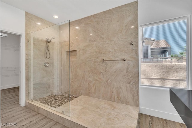 4016 Owlshead Mountain St, Las Vegas, NV 89129 - bathroom featuring a walk in shower, wood finished floors, a spacious closet, and baseboards