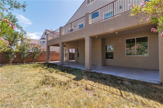 4016 Owlshead Mountain St, Las Vegas, NV 89129 - rear view of house with stucco siding, a patio area, and a balcony