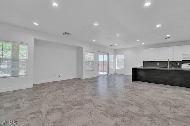 4016 Owlshead Mountain St, Las Vegas, NV 89129 - unfurnished living room with recessed lighting, baseboards, and a sink