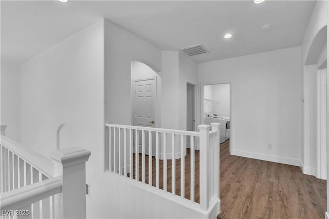 4016 Owlshead Mountain St, Las Vegas, NV 89129 - hall with an upstairs landing, wood finished floors, recessed lighting, arched walkways, and independent washer and dryer