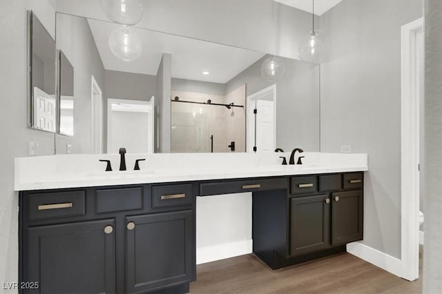 9116 Vista Greens Way Unit 104, Las Vegas, NV 89134 - full bathroom with a shower stall, double vanity, wood finished floors, and baseboards