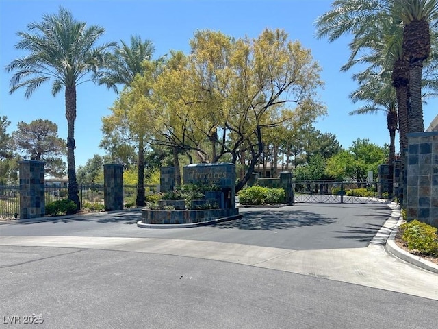 9116 Vista Greens Way Unit 104, Las Vegas, NV 89134 - view of asphalt street featuring a gate, curbs, and a gated entry
