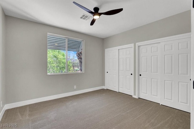 9116 Vista Greens Way Unit 104, Las Vegas, NV 89134 - unfurnished bedroom with two closets, carpet flooring, baseboards, and ceiling fan