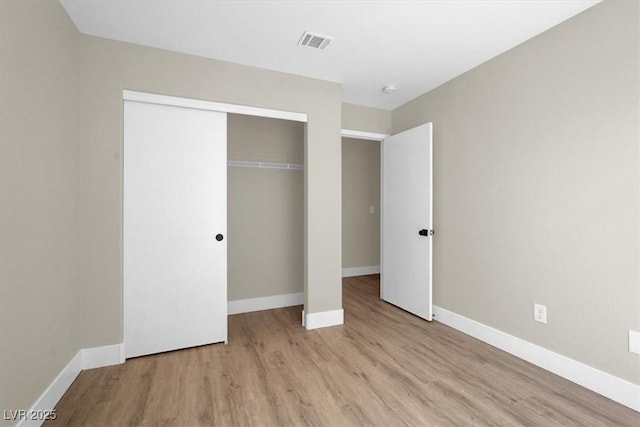 1225 Stonesthrow Cir, North Las Vegas, NV 89031 - unfurnished bedroom with wood finished floors, baseboards, and a closet
