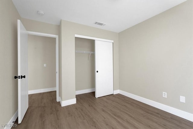 1225 Stonesthrow Cir, North Las Vegas, NV 89031 - unfurnished bedroom featuring wood finished floors, baseboards, and a closet