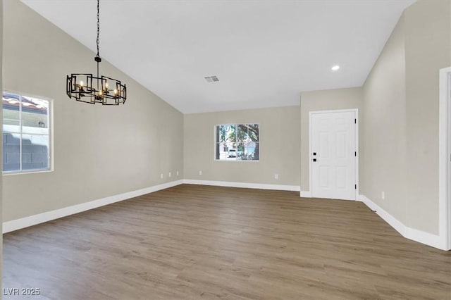 1225 Stonesthrow Cir, North Las Vegas, NV 89031 - unfurnished room featuring a chandelier, wood finished floors, baseboards, vaulted ceiling, and recessed lighting