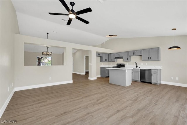 1225 Stonesthrow Cir, North Las Vegas, NV 89031 - kitchen with lofted ceiling, dishwasher, gray cabinets, a sink, and baseboards