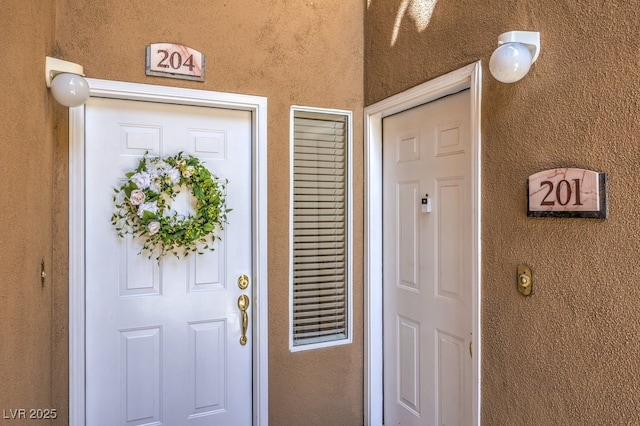 8737 Red Brook Dr Unit 204, Las Vegas, NV 89128 - doorway to property with stucco siding