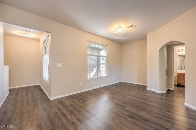 8737 Red Brook Dr Unit 204, Las Vegas, NV 89128 - empty room featuring arched walkways, dark wood-style flooring, and baseboards