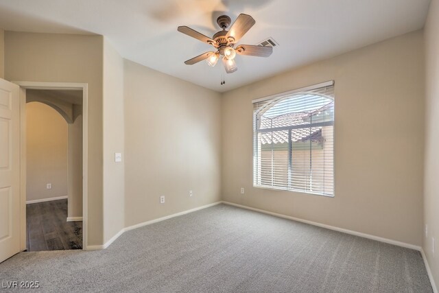8737 Red Brook Dr Unit 204, Las Vegas, NV 89128 - carpeted spare room with arched walkways, a ceiling fan, and baseboards