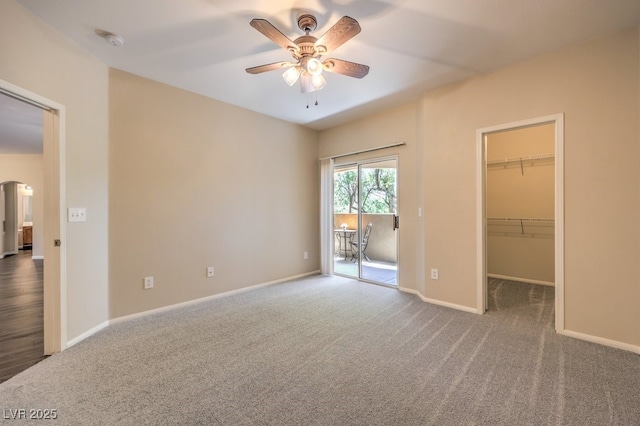 8737 Red Brook Dr Unit 204, Las Vegas, NV 89128 - unfurnished bedroom featuring carpet floors, access to outside, a spacious closet, arched walkways, and baseboards