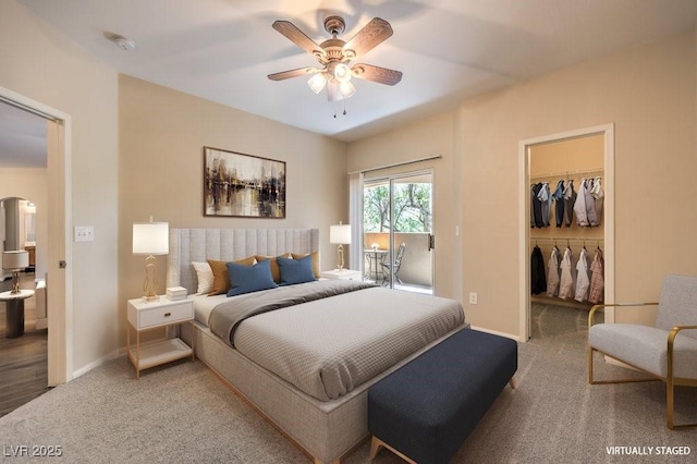 8737 Red Brook Dr Unit 204, Las Vegas, NV 89128 - bedroom with carpet flooring, arched walkways, a spacious closet, baseboards, and access to outside