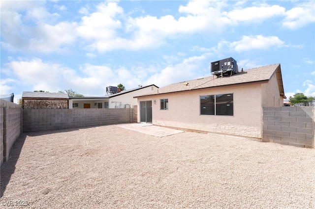 5751 Mabel Rd, Las Vegas, NV 89110 - back of house featuring stucco siding, a fenced backyard, and cooling unit