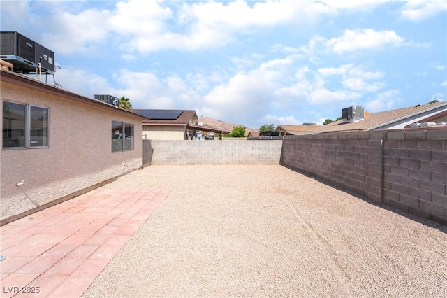 5751 Mabel Rd, Las Vegas, NV 89110 - fenced backyard with cooling unit and a patio