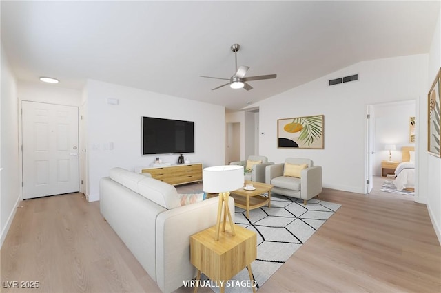 5751 Mabel Rd, Las Vegas, NV 89110 - living area featuring vaulted ceiling, light wood-style flooring, a ceiling fan, and baseboards