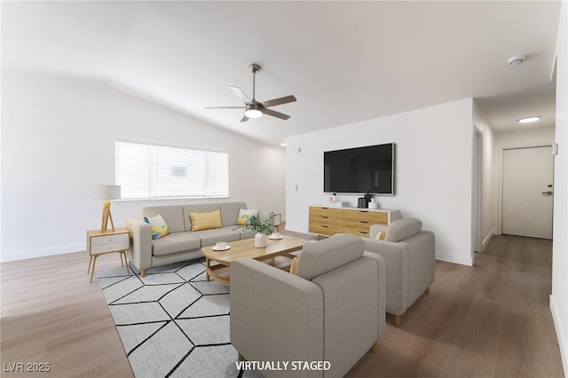 5751 Mabel Rd, Las Vegas, NV 89110 - living room featuring ceiling fan, light wood-style floors, vaulted ceiling, and baseboards