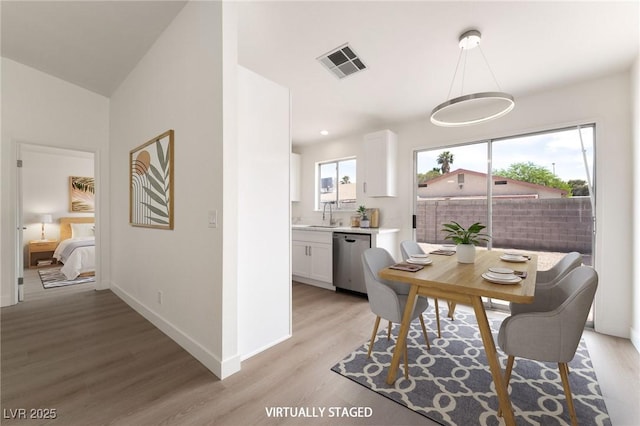 5751 Mabel Rd, Las Vegas, NV 89110 - dining room featuring light wood-style flooring and baseboards