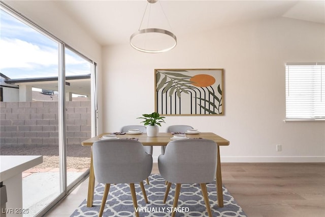 5751 Mabel Rd, Las Vegas, NV 89110 - dining room featuring wood finished floors, plenty of natural light, baseboards, and lofted ceiling