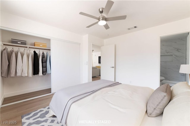 5751 Mabel Rd, Las Vegas, NV 89110 - bedroom featuring a closet, wood finished floors, ensuite bathroom, baseboards, and a ceiling fan