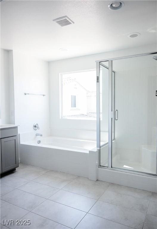 1703 Game Garden Rd, North Las Vegas, NV 89031 - full bathroom with a garden tub, vanity, a shower stall, and tile patterned flooring