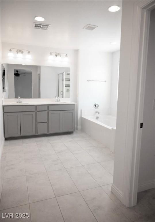 1703 Game Garden Rd, North Las Vegas, NV 89031 - full bath with double vanity, a bath, a ceiling fan, baseboards, and tile patterned flooring