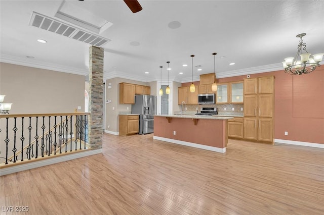 9975 Sand Key St, Las Vegas, NV 89178 - kitchen featuring appliances with stainless steel finishes, a chandelier, light wood-style flooring, light countertops, and recessed lighting