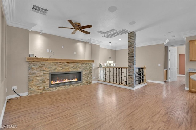 9975 Sand Key St, Las Vegas, NV 89178 - unfurnished living room with a ceiling fan, a fireplace, ornamental molding, light wood-style floors, and a chandelier