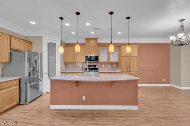 9975 Sand Key St, Las Vegas, NV 89178 - kitchen with stainless steel appliances, a kitchen breakfast bar, decorative backsplash, a kitchen island with sink, and light wood-type flooring