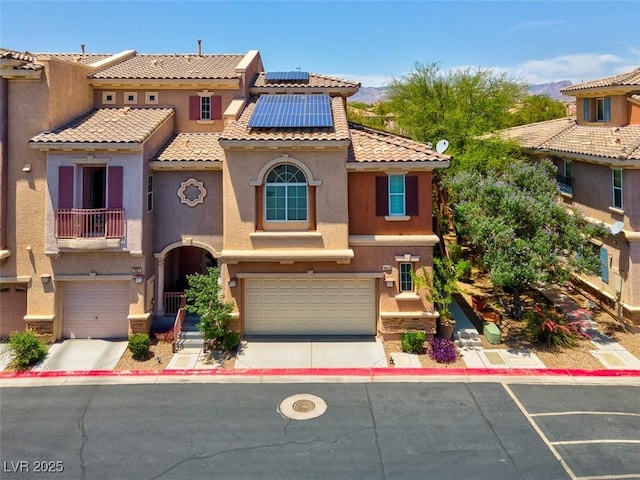 9975 Sand Key St, Las Vegas, NV 89178 - view of front of property with stucco siding, an attached garage, solar panels, and a tiled roof
