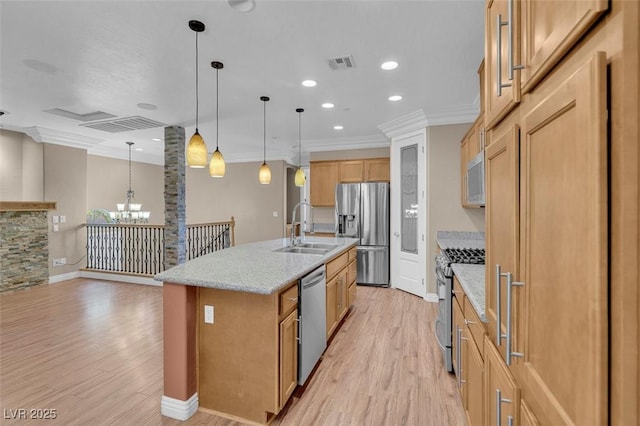 9975 Sand Key St, Las Vegas, NV 89178 - kitchen featuring appliances with stainless steel finishes, a chandelier, light wood-style flooring, crown molding, and light stone countertops