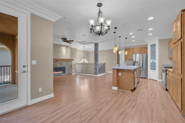 9975 Sand Key St, Las Vegas, NV 89178 - kitchen with stainless steel appliances, a ceiling fan, a chandelier, open floor plan, and crown molding